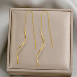 Boucles d'oreilles longues avec design ondulé
